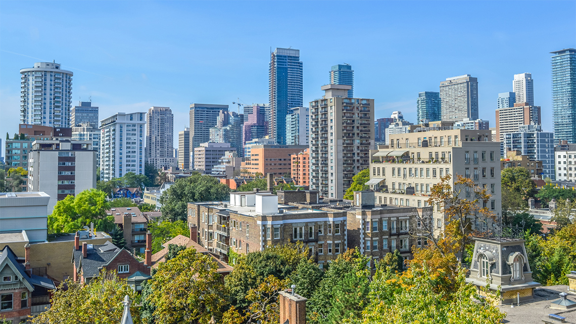 There are a lot of buildings such has work offices, apartments, and condos all close together. There are also a few homes with trees in the surrounding area all which don't have a lot of space between them.