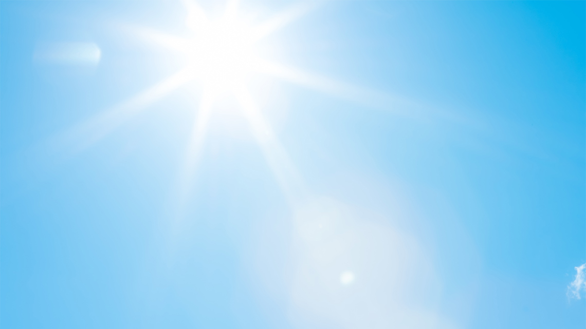 The sun shining in the sky.