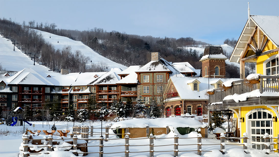 An image of Blue mountain ski resort showing the resort with the ski hills in the background