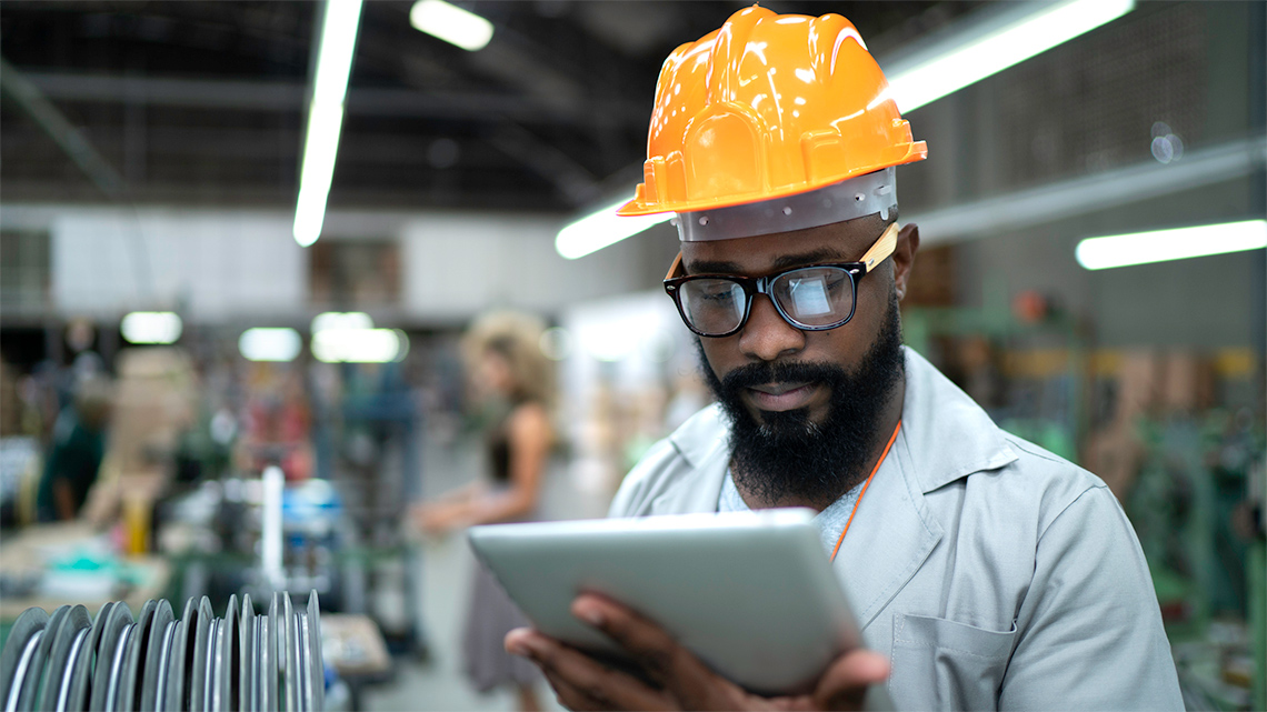 A robotics control engineer in a car part factory