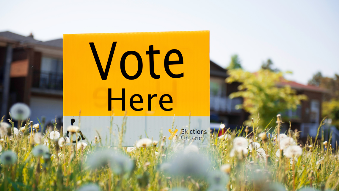 A sign that reads ‘vote here.’