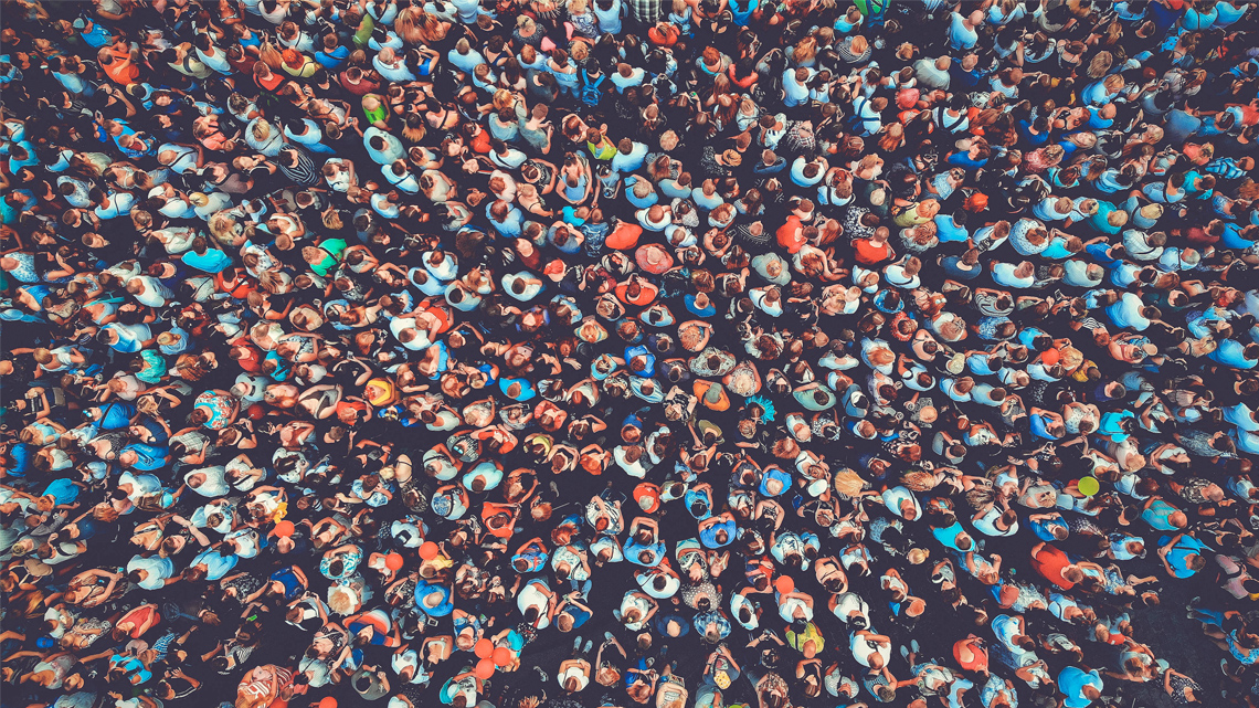 Various people crowded together, shoulder to shoulder.