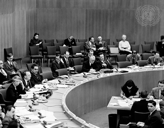 First meeting of the Commission on Human Rights. There is a room full of people sitting at a large round table.